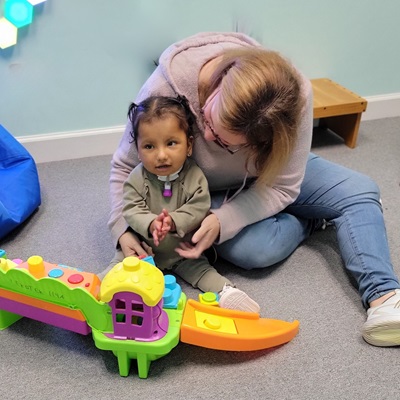 child plays with Lekotek leader