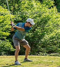 golfer takes his shot