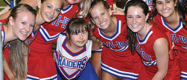 child and cheerleaders at football game