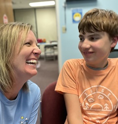 volunteer helps child on computer